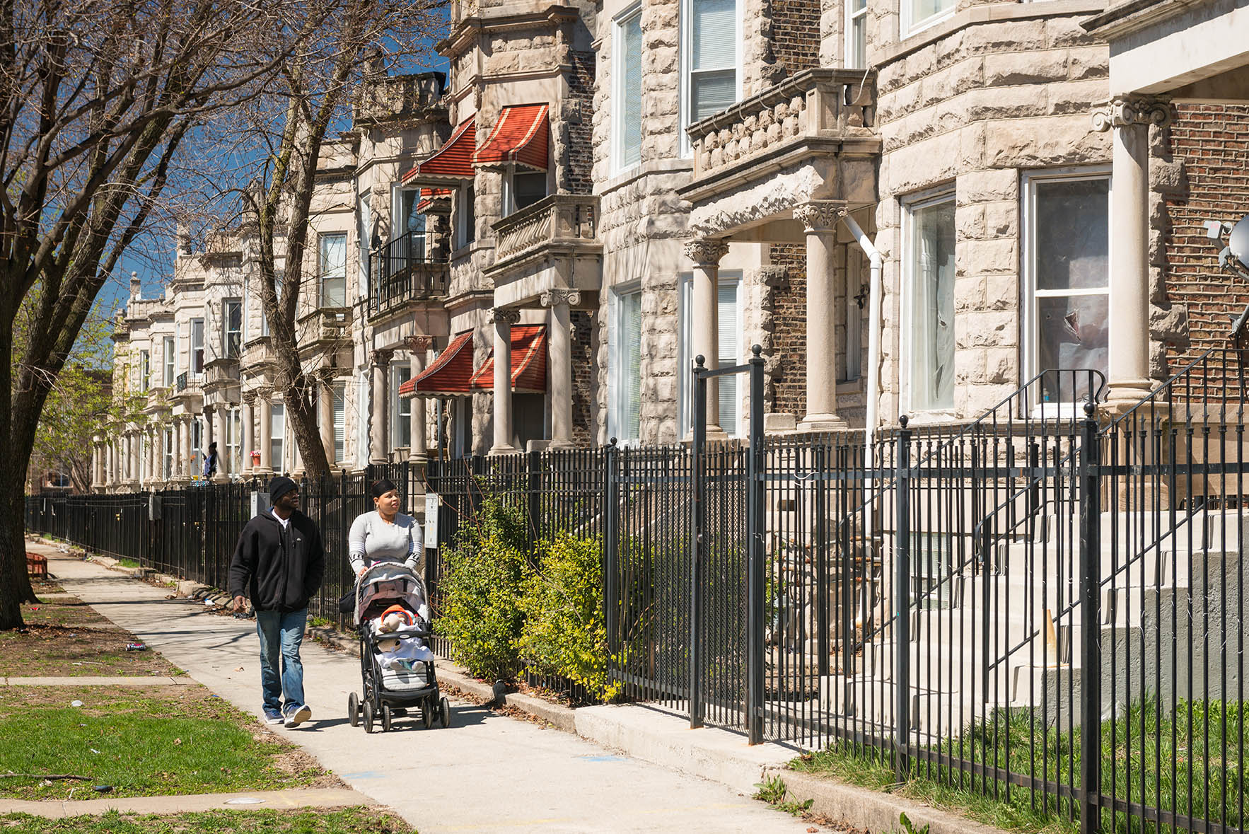 Image of family walking in front of homes in West Garfield Park